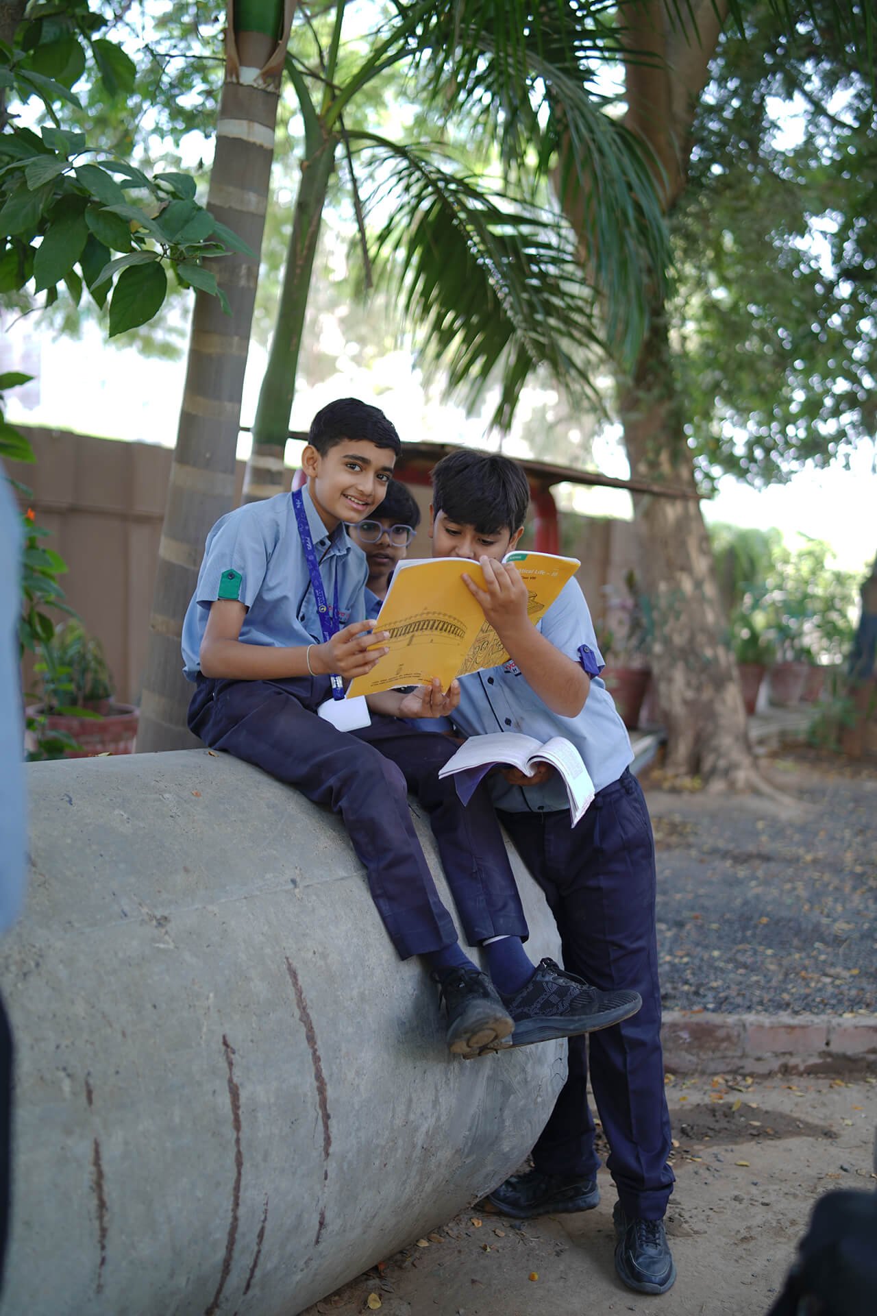 Students Reading Books Together Outdoors on Campus