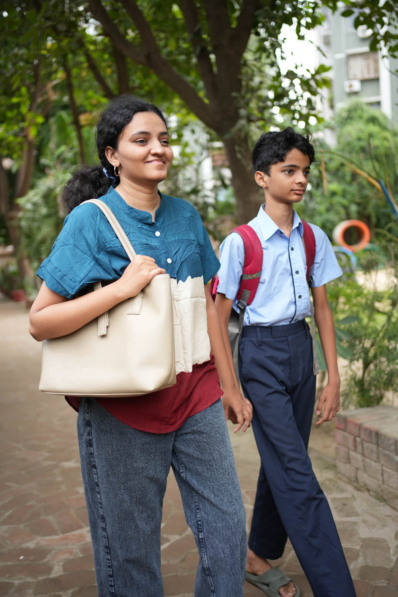 Parent Walking Student to School on Campus Grounds