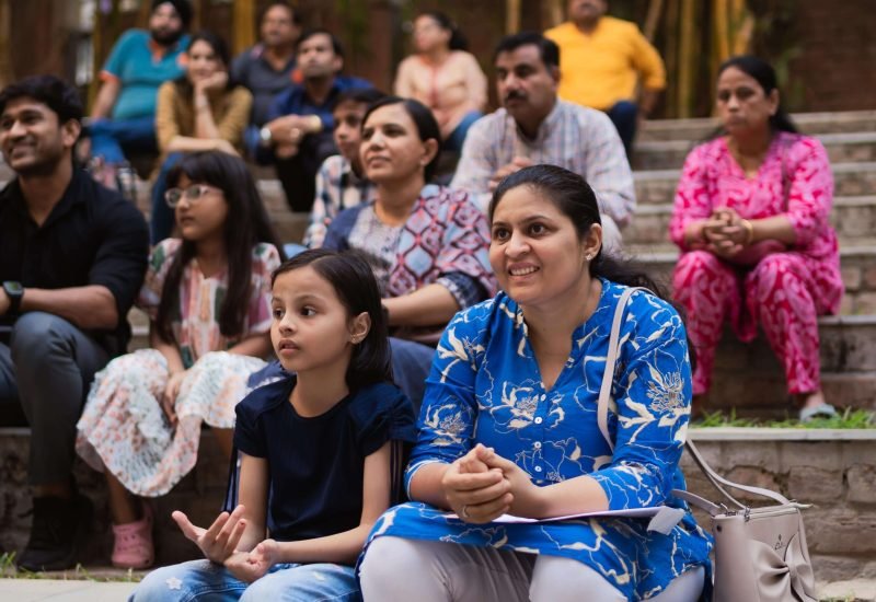 Parents and Students Audience Seated Outdoors for School Event Presentation